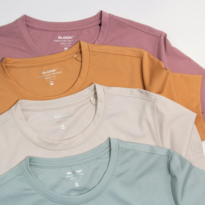 a bunch of different colored shirts on a white background